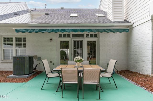 a patio with table and chairs