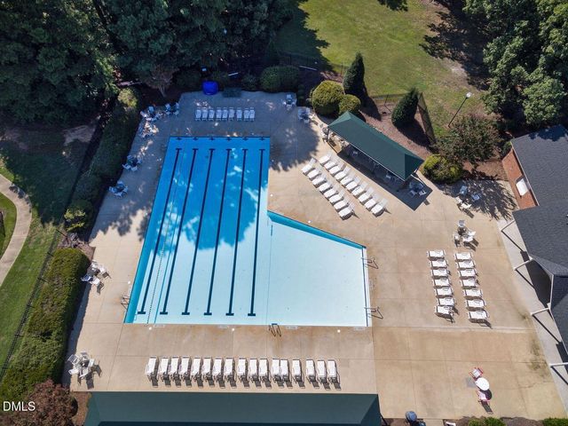 an aerial view of a house with a swimming pool and outdoor seating