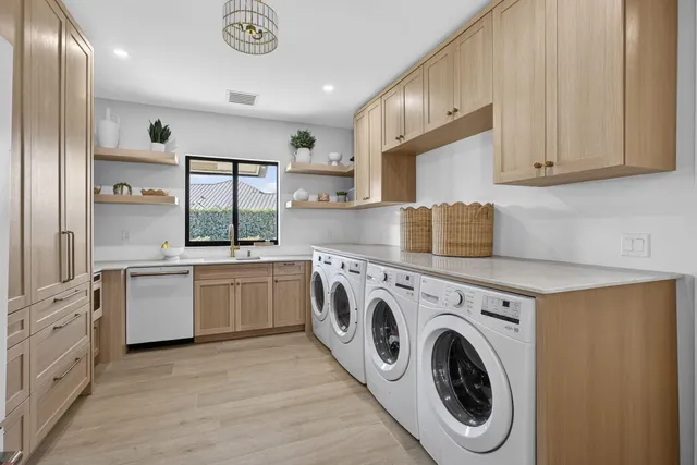 a view of a white house with a swimming pool and a yard