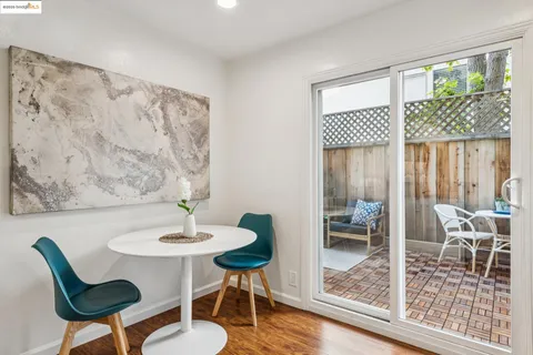 a dining room with wooden floor and a table