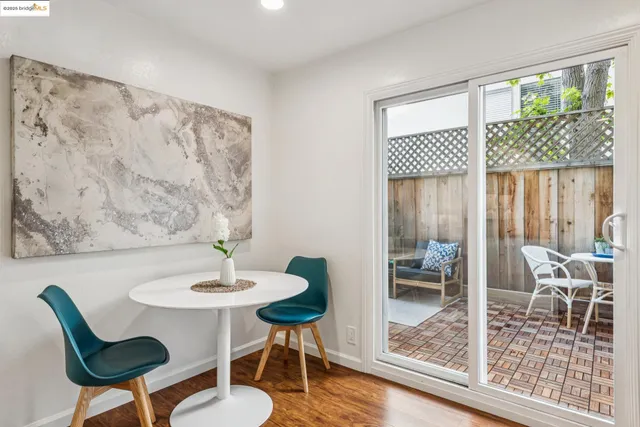 a dining room with wooden floor and a table
