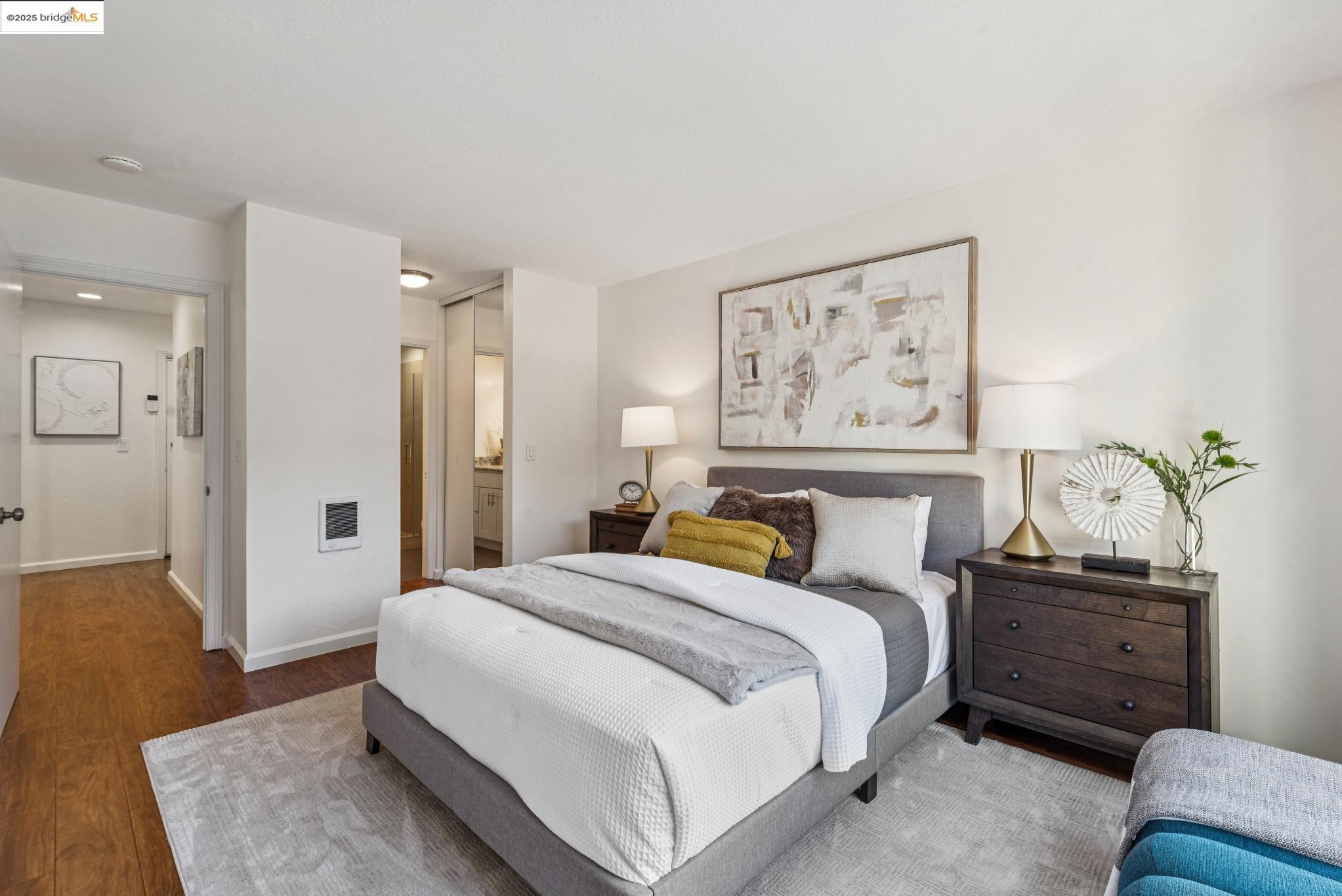 651 Oakland Avenue, Unit 1E Oakland, CA 94611 - Photo 16 of 28 a spacious bedroom with a bed and a couch