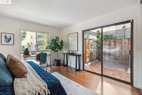 a spacious bedroom with a balcony a bed and glass door