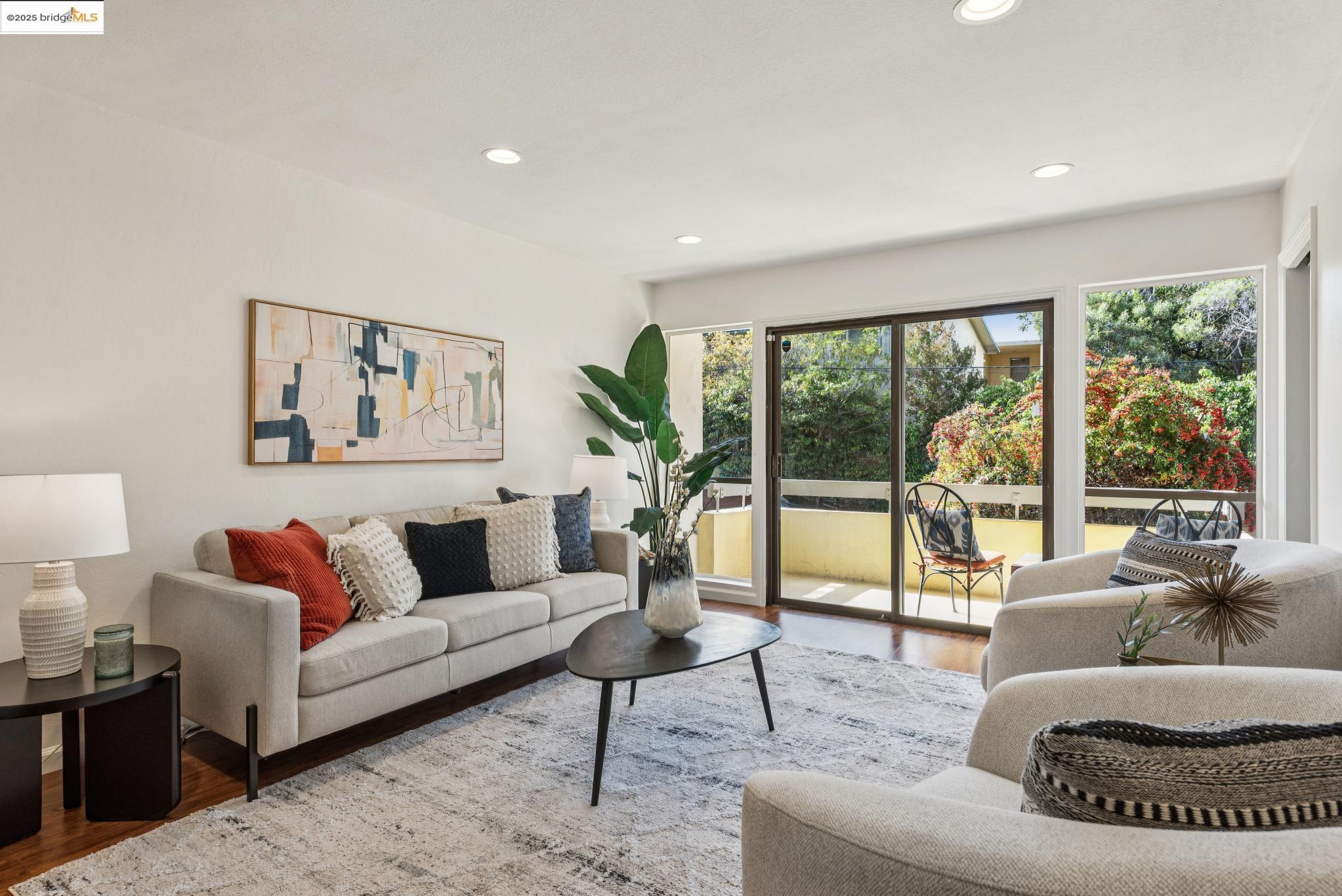 651 Oakland Avenue, Unit 1E Oakland, CA 94611 - Photo 2 of 28 a living room with furniture and a large window