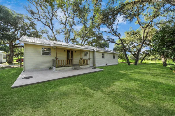 a view of a house with a backyard