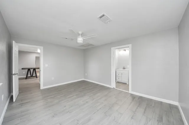 a view of an empty room with wooden floor