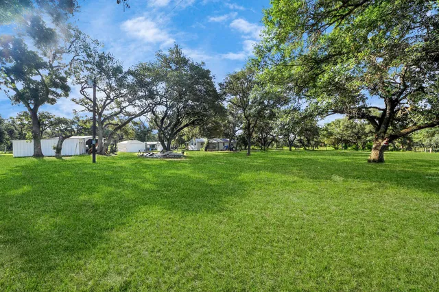 a view of grassy field with benches