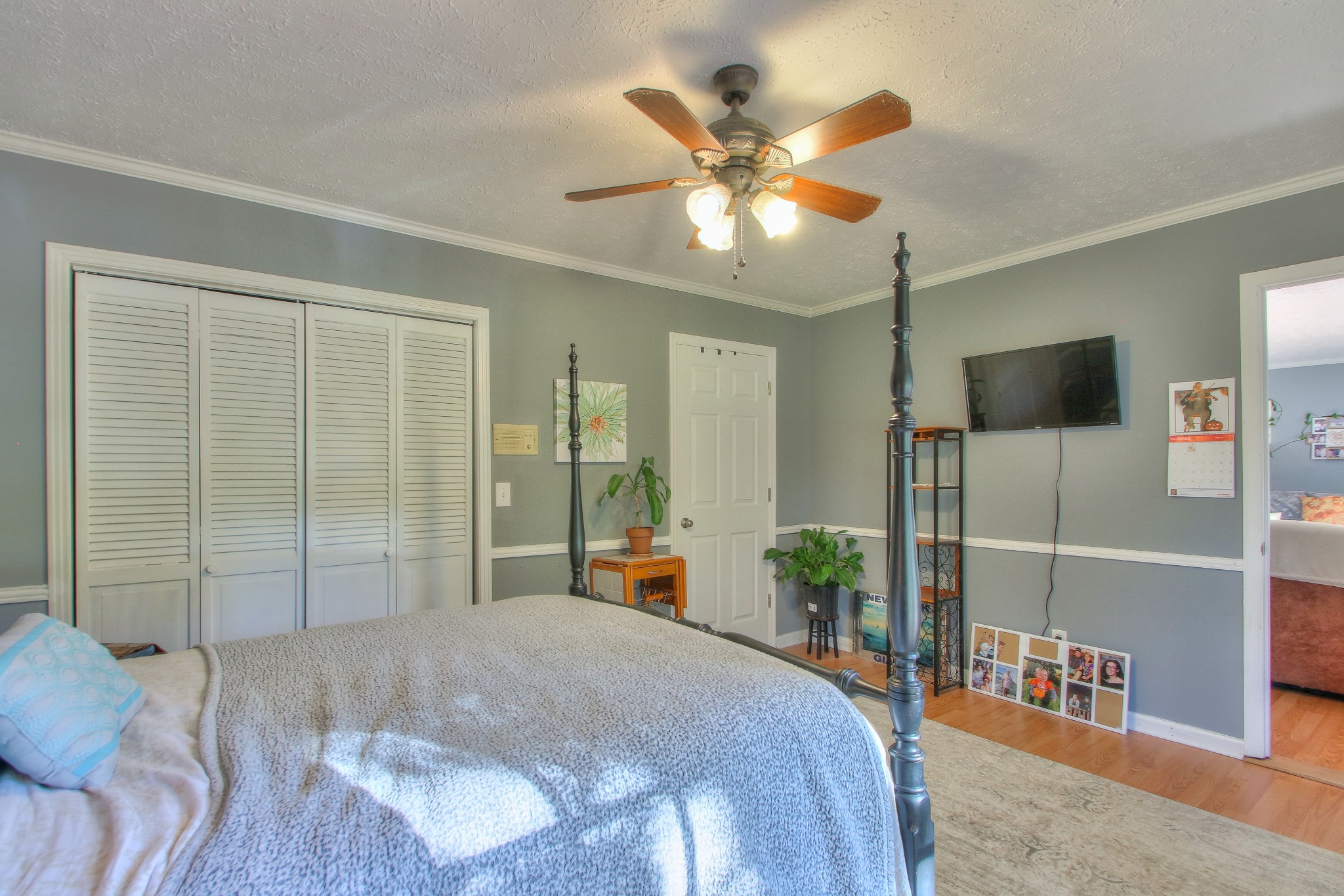 416 Harsh Lane Castalian Springs, TN 37031 - Photo 13 of 31 a bedroom with a large bed and a chandelier