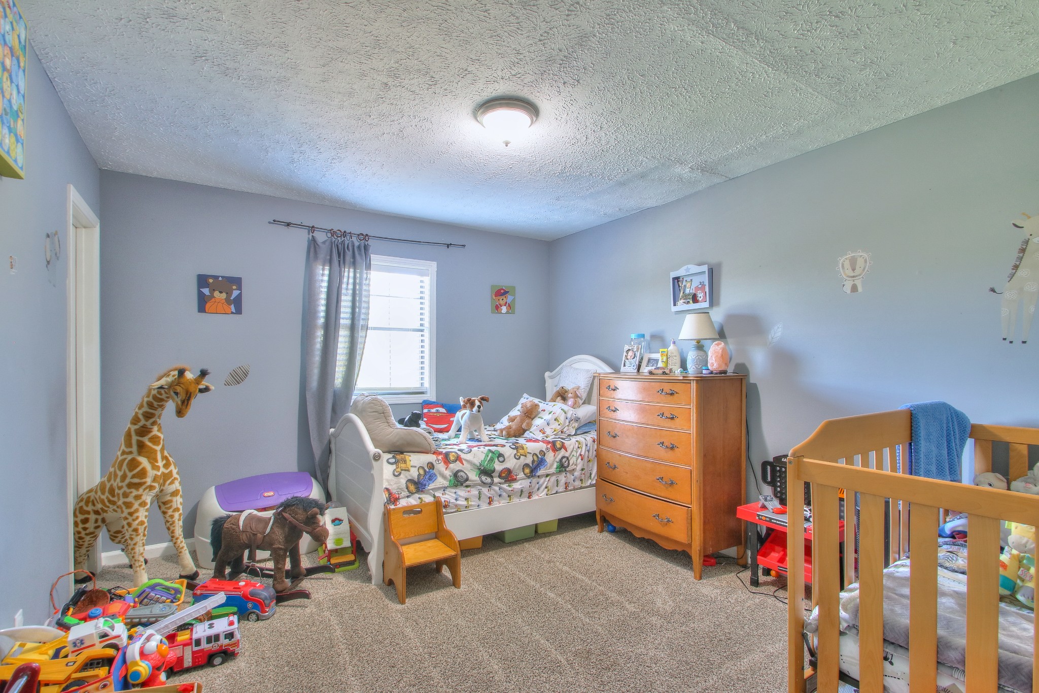 416 Harsh Lane Castalian Springs, TN 37031 - Photo 17 of 31 a bedroom with baby toys and dresser