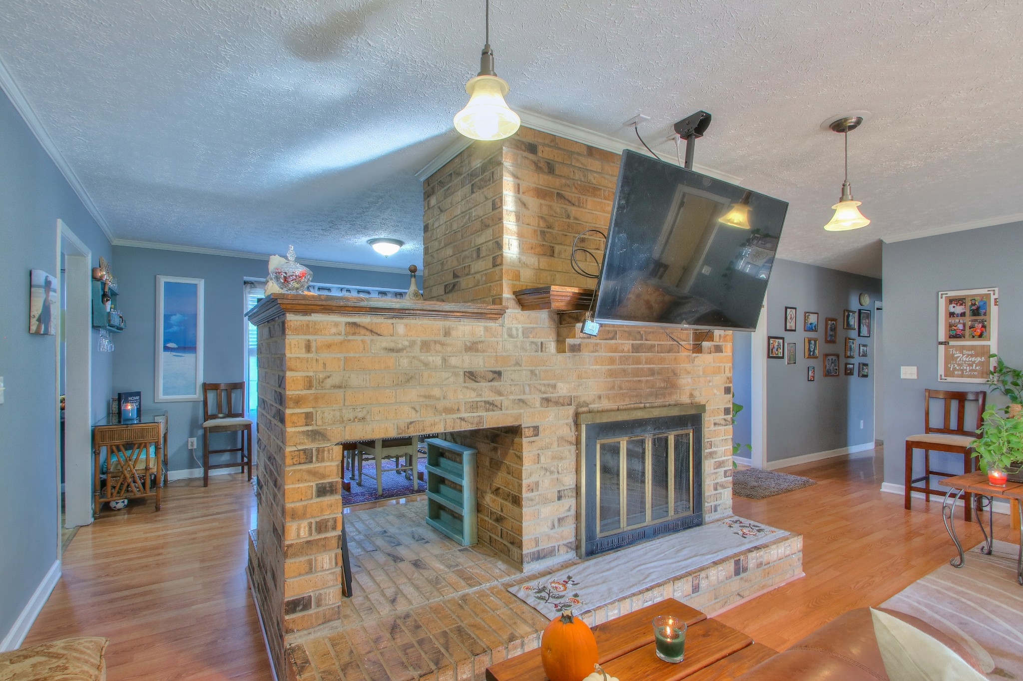 416 Harsh Lane Castalian Springs, TN 37031 - Photo 7 of 31 a living room with furniture a fireplace and a chandelier