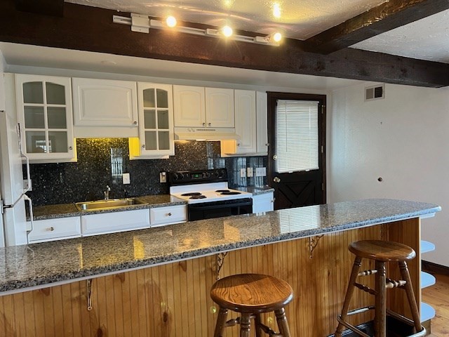 16 A Stowe Road, Unit A Southborough, MA 01772 - Photo 5 of 10 a kitchen with stainless steel appliances granite countertop a granite counter tops and a view of living room