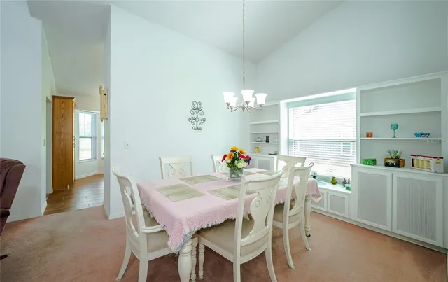 a view of a dining room with furniture and window