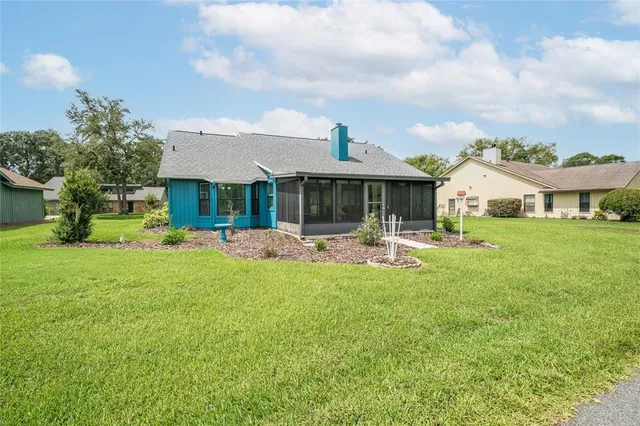a front view of a house with garden and lake view