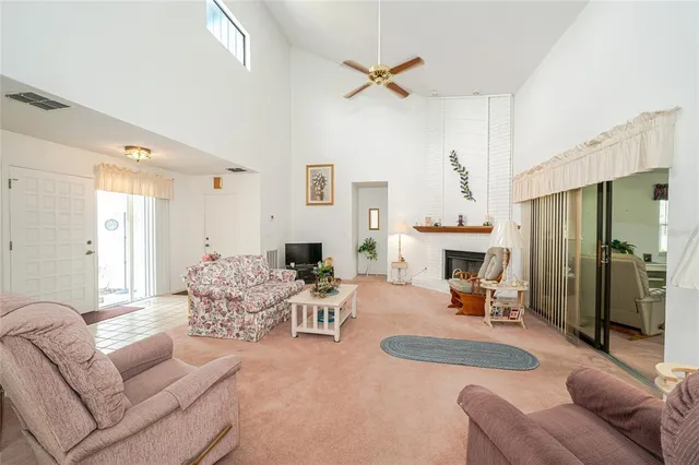 a living room with furniture fireplace and a large window
