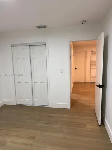 a view of a room with wooden floor