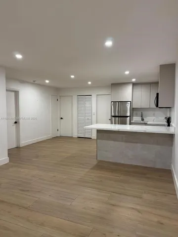 a view of kitchen with wooden cabinet and stainless steel appliances
