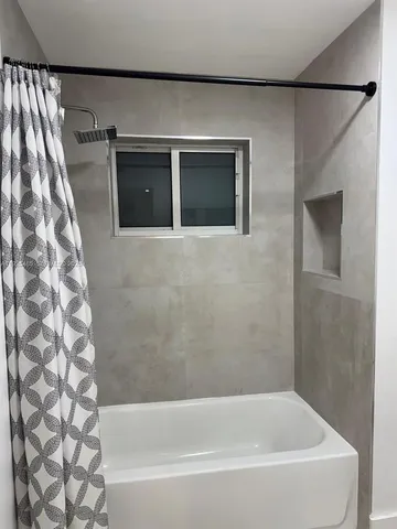 a bathroom with a bathtub and a shower