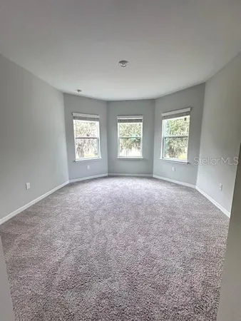 a view of room with window and brick walls