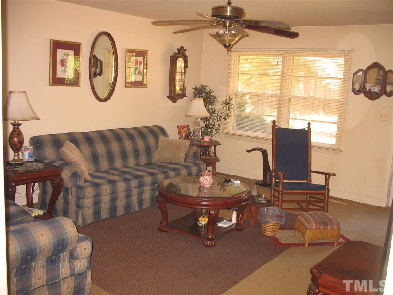 727 Locust Lane Raleigh, NC 27603 - Photo 3 of 4 a living room with furniture a window and gym equipment