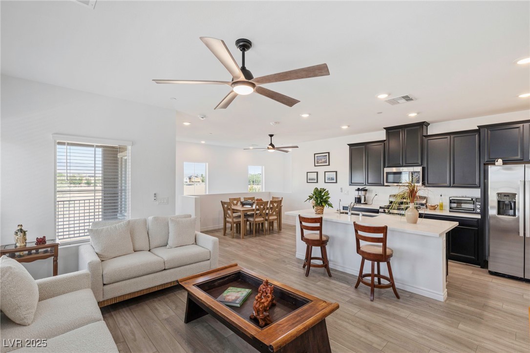 7230 North Decatur Boulevard, Unit 6 North Las Vegas, NV 89084 - Photo 1 of 27 Living area with plenty of natural light, a ceiling fan, recessed lighting, and light wood-style flooring