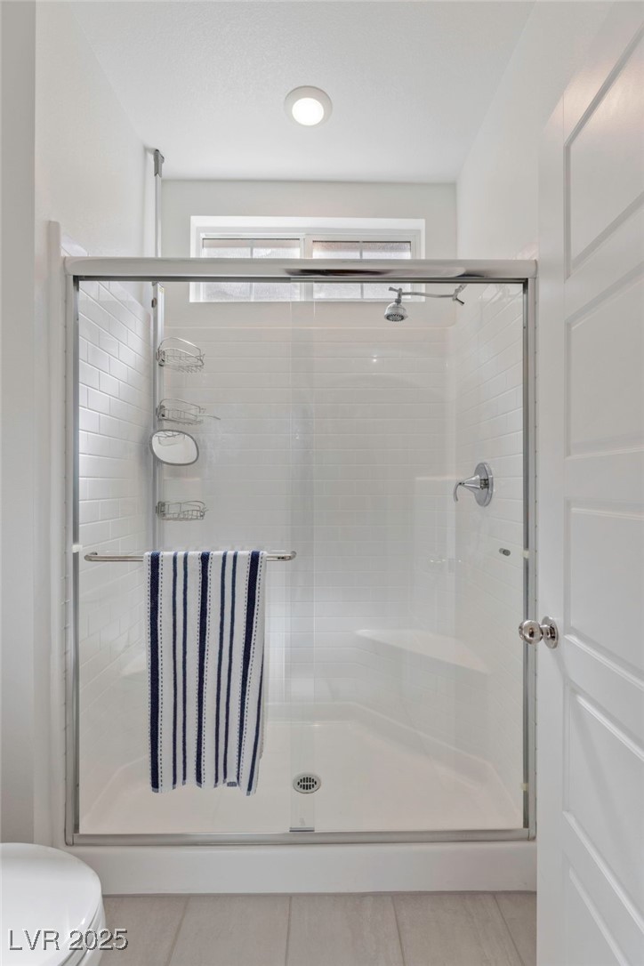 7230 North Decatur Boulevard, Unit 6 North Las Vegas, NV 89084 - Photo 15 of 27 Full bathroom with a stall shower and tile patterned flooring