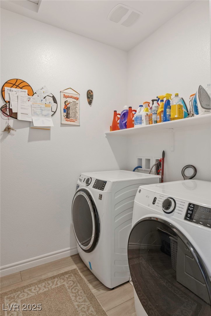 7230 North Decatur Boulevard, Unit 6 North Las Vegas, NV 89084 - Photo 19 of 27 Washroom with washer and clothes dryer and light wood-type flooring