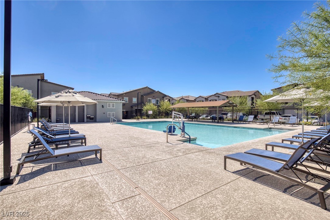 7230 North Decatur Boulevard, Unit 6 North Las Vegas, NV 89084 - Photo 22 of 27 Community pool featuring a patio and a residential view