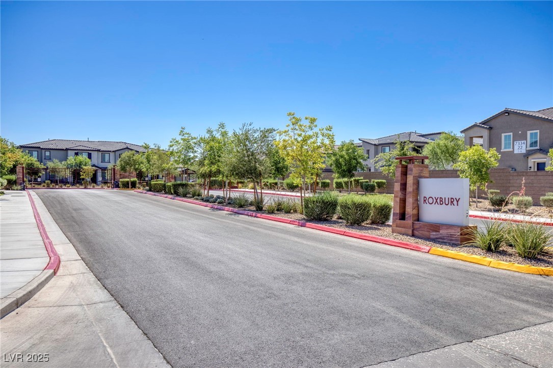 7230 North Decatur Boulevard, Unit 6 North Las Vegas, NV 89084 - Photo 25 of 27 View of asphalt road featuring curbs, sidewalks, and a residential view