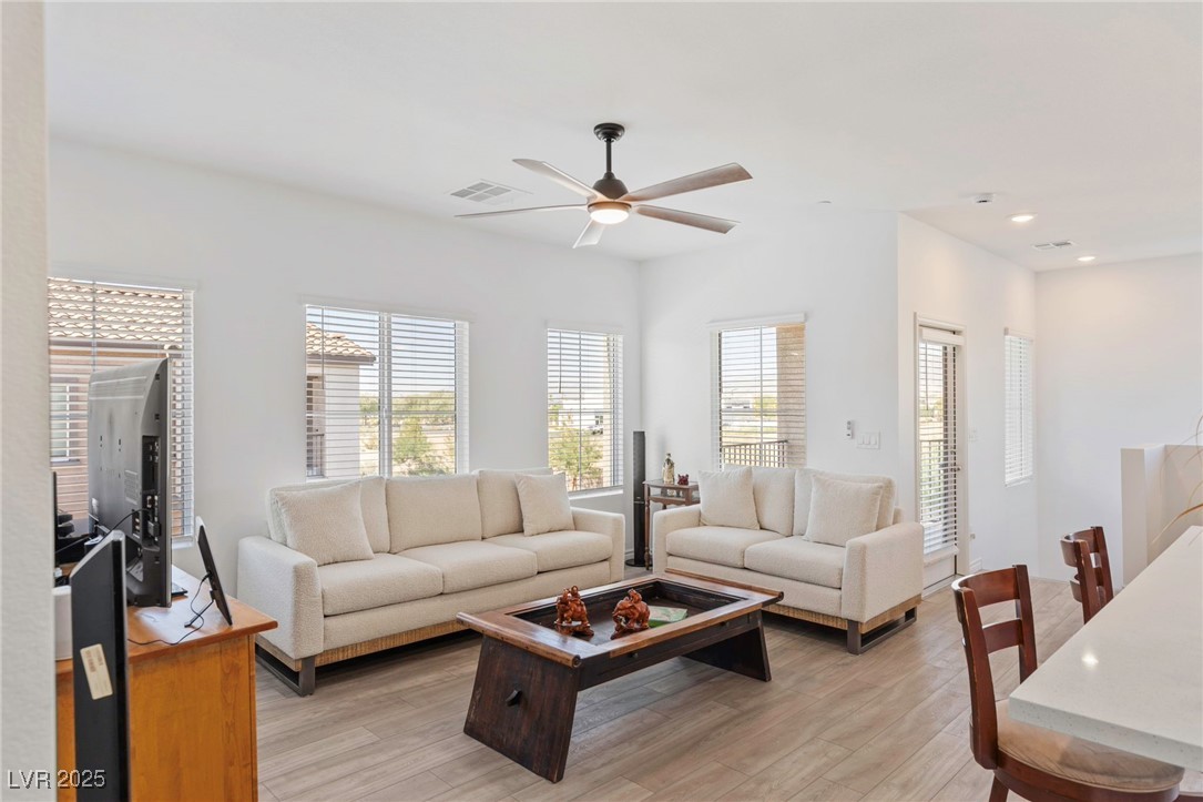 7230 North Decatur Boulevard, Unit 6 North Las Vegas, NV 89084 - Photo 4 of 27 Living area with healthy amount of natural light, light wood-style flooring, ceiling fan, and recessed lighting