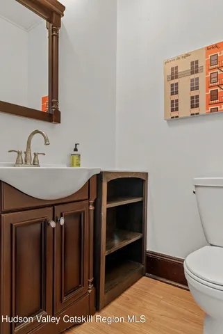 a bathroom with a sink a toilet and a mirror