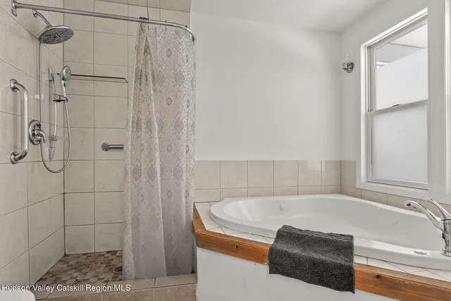 a bath tub sitting next to a shower