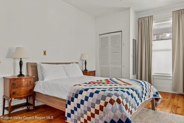 a bedroom with a bed and lamp