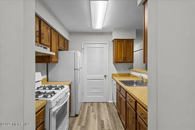 a kitchen with a sink a stove and refrigerator