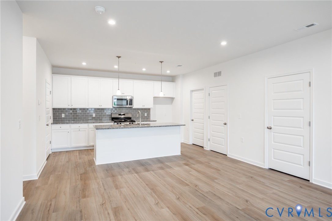 3731 Maze Runner Drive Midlothian, VA 23112 - Photo 1 of 32 a kitchen with a refrigerator and white cabinets