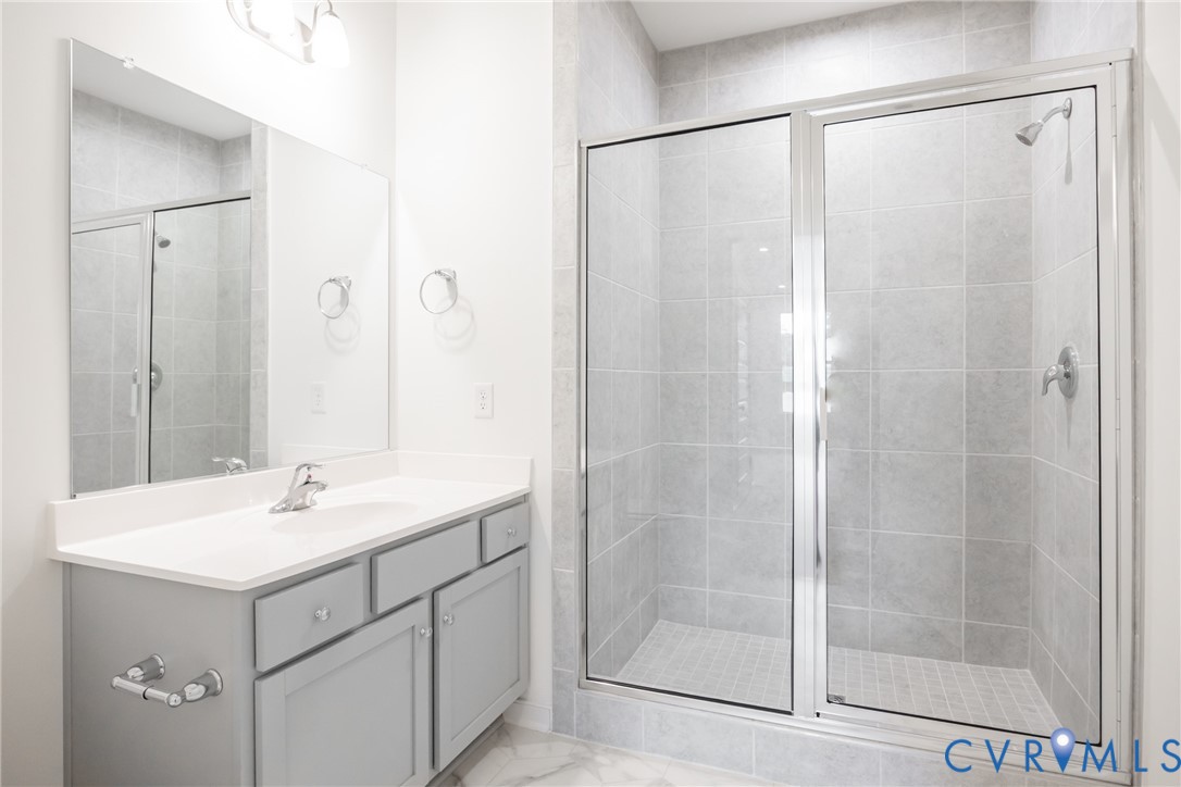 3731 Maze Runner Drive Midlothian, VA 23112 - Photo 14 of 32 a bathroom with a shower sink and mirror