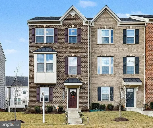 a front view of a residential apartment building with a yard