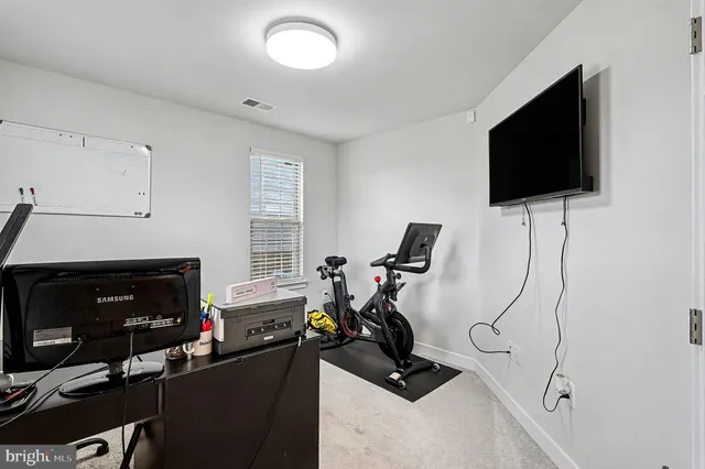 a view of a workspace with furniture and a flat screen tv