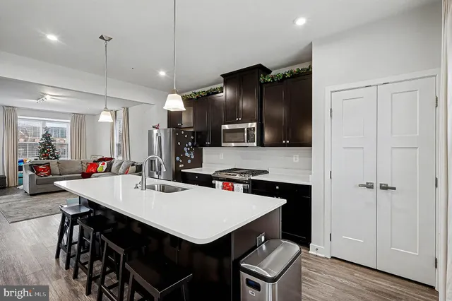 a kitchen with a table chairs refrigerator and microwave