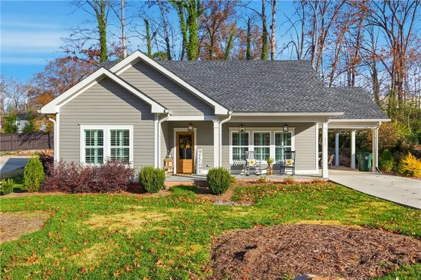 a front view of house with yard and outdoor seating