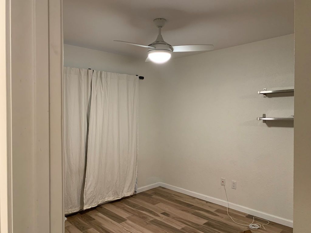 4404 Bouvet Court Austin, TX 78727 - Photo 11 of 16 a view of empty room with wooden floor