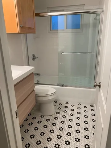 a bathroom with a toilet and a shower