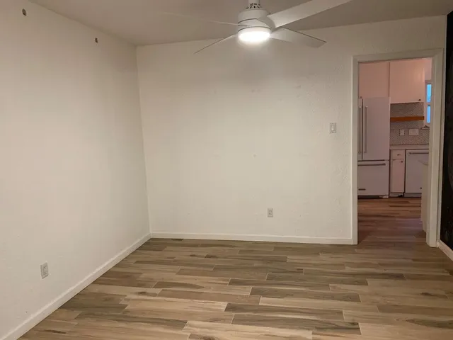 a view of a room with wooden floor