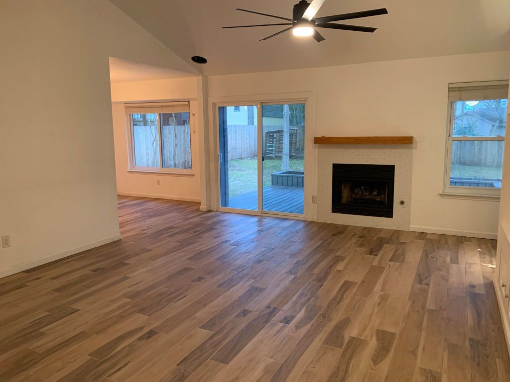 4404 Bouvet Court Austin, TX 78727 - Photo 3 of 16 wooden floor fireplace and windows in an empty room