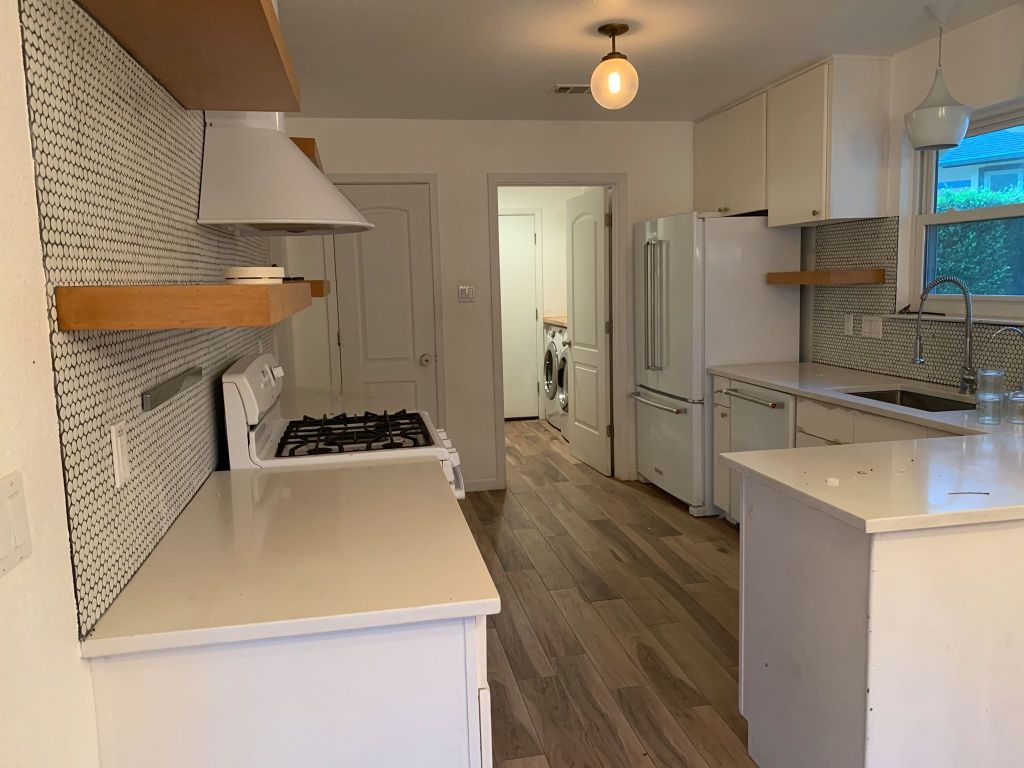 4404 Bouvet Court Austin, TX 78727 - Photo 4 of 16 a kitchen that has a sink stainless steel appliances a counter space and cabinets