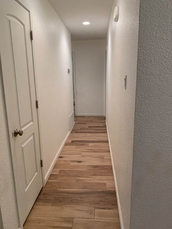 4404 Bouvet Court Austin, TX 78727 - Photo 7 of 16 a view of a hallway with wooden floor and staircase