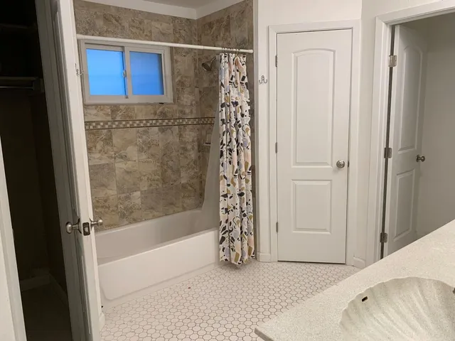 a bathroom with a bathtub and shower
