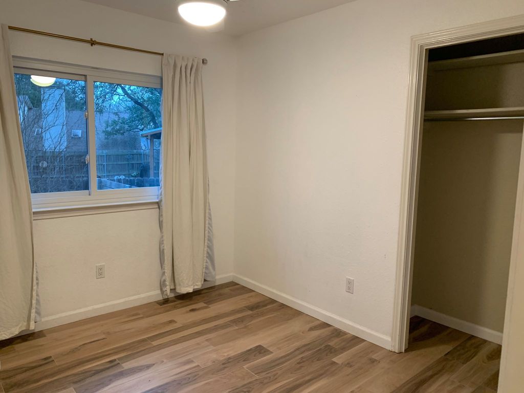 4404 Bouvet Court Austin, TX 78727 - Photo 10 of 16 a view of empty room with wooden floor and fan