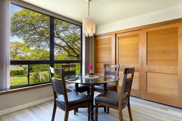 a dining room with furniture window and wooden floor
