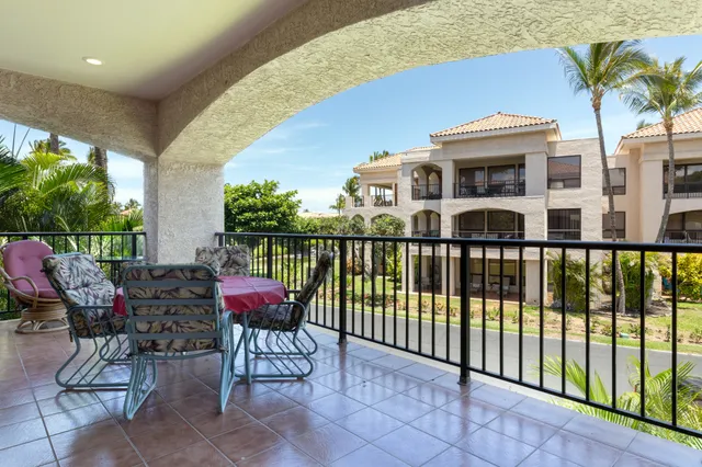 a view of a patio with chairs and plants