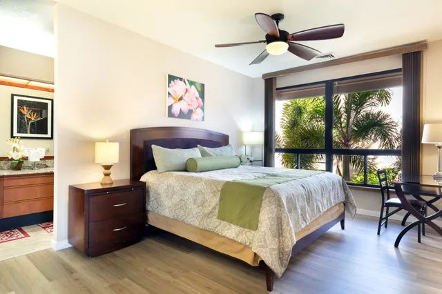 a bedroom with a bed and a chandelier